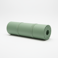 Rolled-up sage green yoga mat on white background
